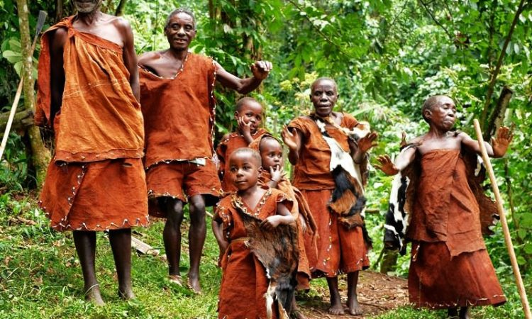 A Batwa family of Uganda wearing their cultural wear getting ready for a cultural dance